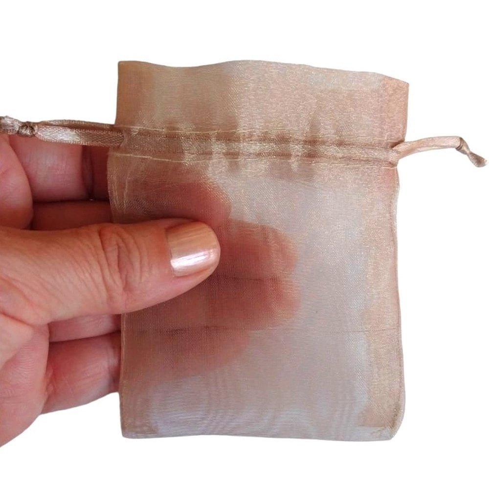 10 Sacos de Organza 6x8cm Amarula O tamanho compacto de 6x8cm torna esse saquinho uma opção prática e perfeita para anéis ou outras joias pequenas. Organza cristal é um tecido semi transparente e delicado, permite que o brilho e o design de suas joias sejam vistos claramente, ao mesmo tempo em que as protege de arranhões e poeira. Possui duas fitas embutidas para fechamento fácil, dispensando a necessidade de laços ou outros fechos. Disponíveis em diversas medidas e cores, nossos sacos de organza cristal estão prontos em estoque ou podem ser produzidos sob encomenda para atender maiores quantidades. Caso tenha alguma duvida, nossa equipe está disponível para ajudá-lo(a) através do WhatsApp (11) 98201-8766. Lazzo Atacado de Embalagens para Joias.